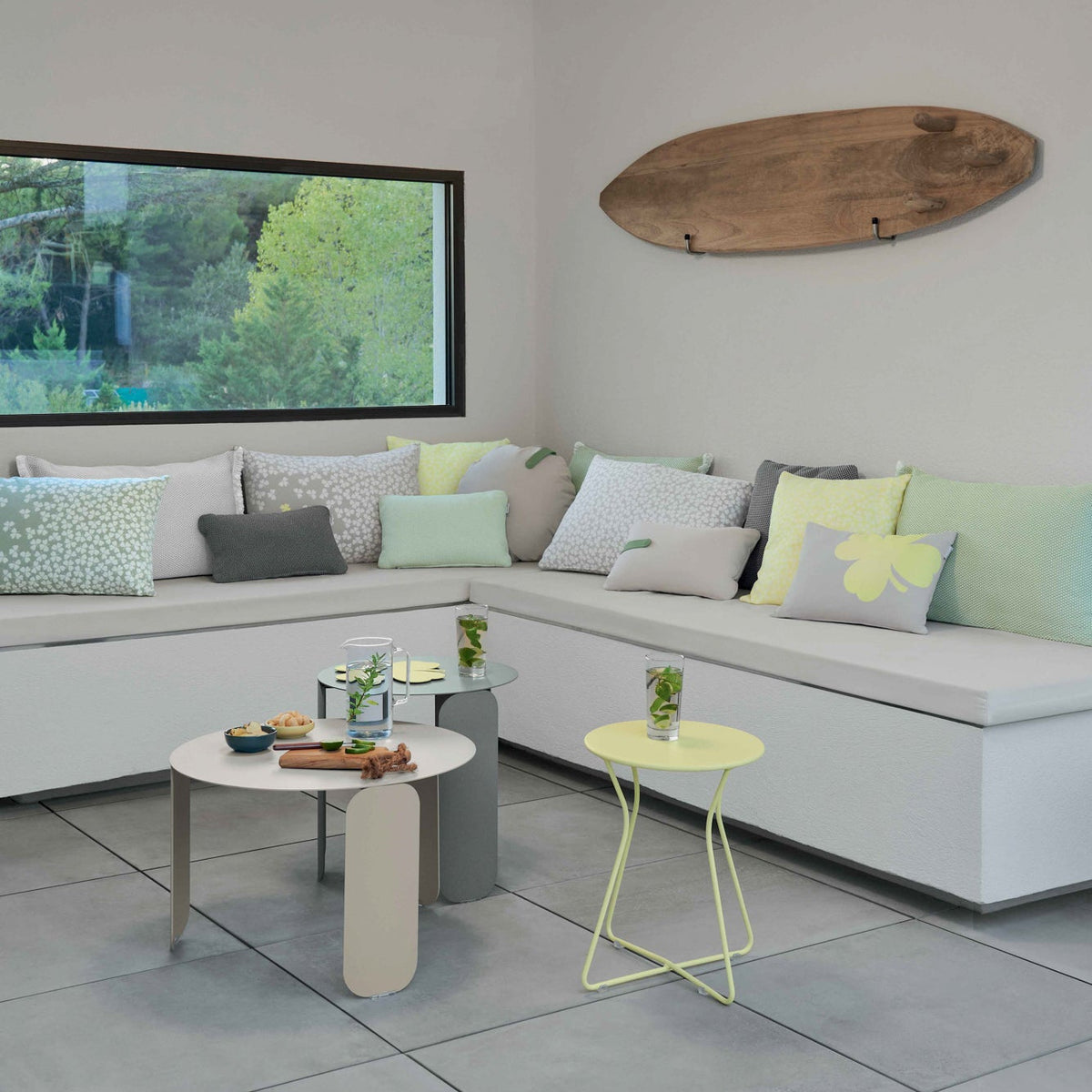 Modern living room with a sectional sofa, coffee table, and decorative items.