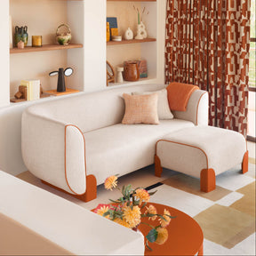 Modern living room with a beige sofa, orange coffee table, and decorative shelves.