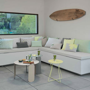 Modern living room with a sectional sofa, coffee table, and decorative items.