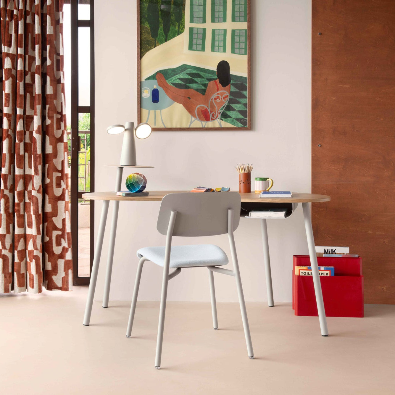 Modern office space with a desk, chair, and decorative elements.