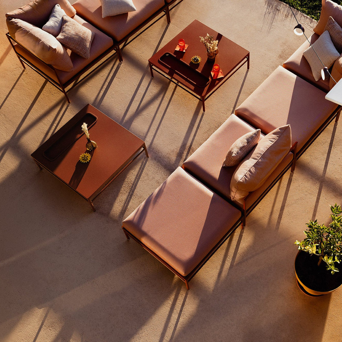 Outdoor patio furniture set with cushions on a concrete patio.