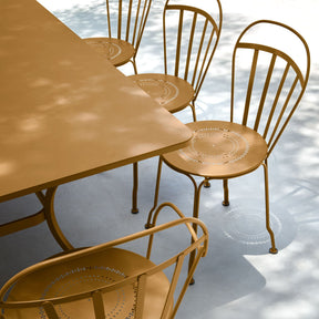 Gingerbread coloured outdoor dining set with table and chairs.